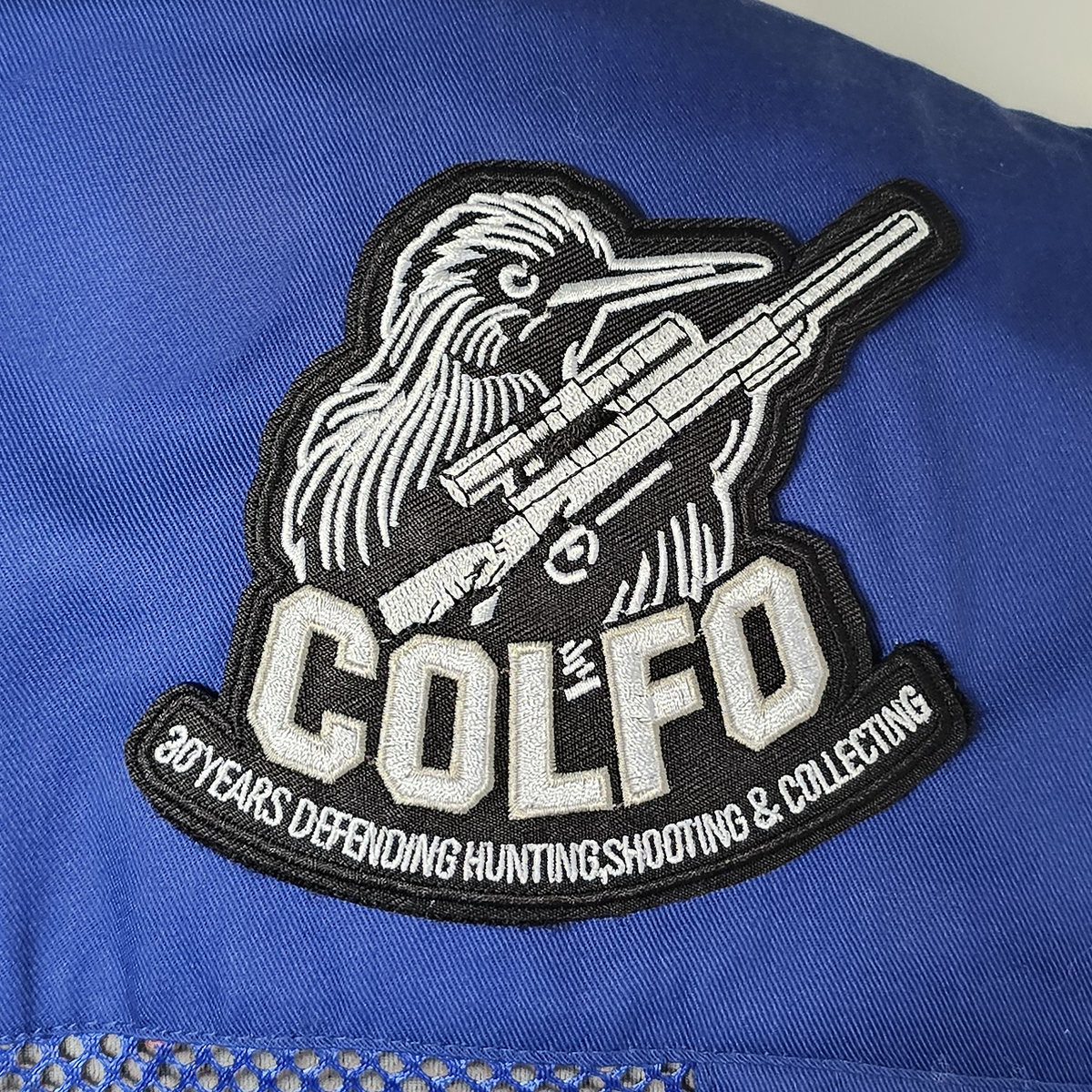 COLFO 30 Years patch on a blue shooting vest